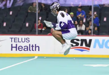 lacrosse player jumping in the air