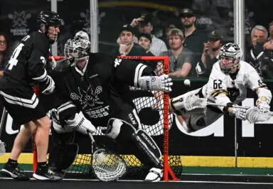 Lacrosse goalie blocks shot