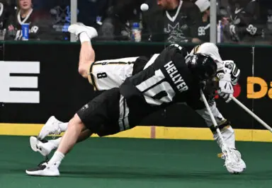 Two lacrosse players falling to the ground