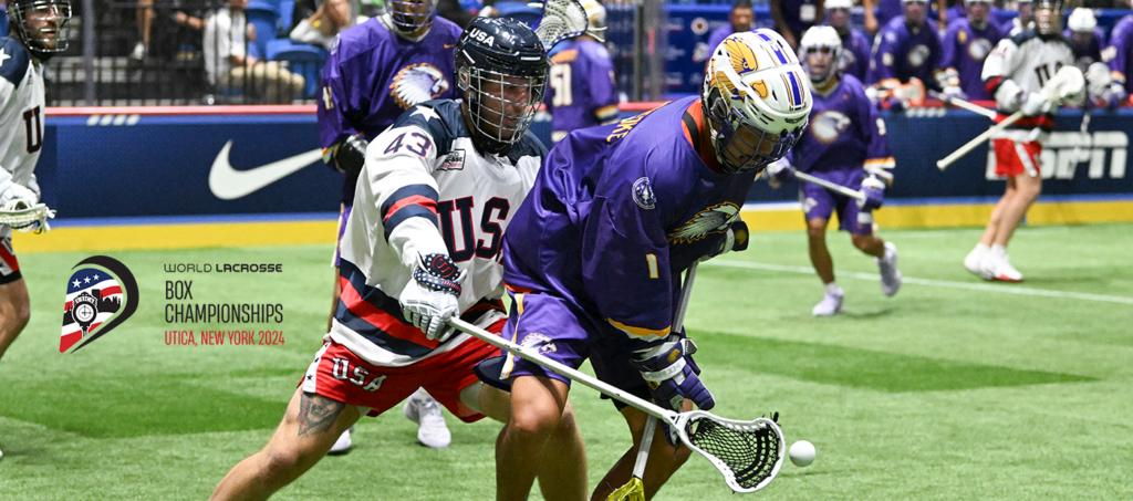 Two lacrosse players engaged in a struggle for the ball during the World Lacrosse Box Championships.