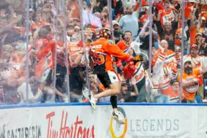 CLS_2025051600442.jpg: Lacrosse player celebrating with fans, team jerseys visible, Tim Hortons and Legends logos present