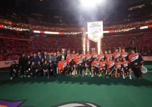 Team celebrating under a "World Champions Bandits 2024" banner on a sports field