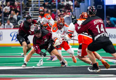 Buffalo Bandits player number 41 competes for the ball against Colorado Mammoth opponents on a lacrosse field