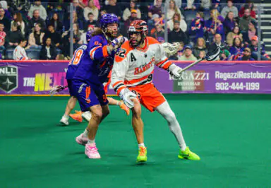 Buffalo Bandits player in action against Halifax Thunderbirds during a competitive lacrosse match