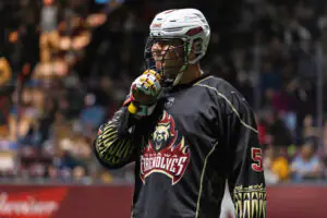 Player in Oshawa Firewolves gear, helmet, and gloves on field