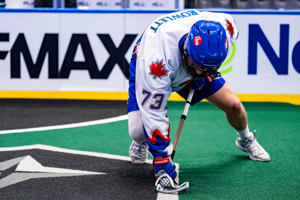 Lacrosse player with "Rowlett" on jersey in action, number 73